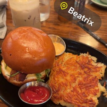 Beatrix - Streeterville - Bacon and egg Bacon, Egg & Cheddar Sandwich with iced banana cold brew latte. - New American Near Me - Chicago, Illinois