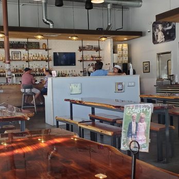 Industry - the inside of a restaurant with tables and benches - New American Near Me - San Marcos, Texas