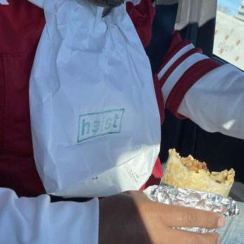 Heist Restaurant - The hubby making sure to devour this burrito while also preserving his Jersey. To go bag aka bib - Coffee & Tea Near Me - San Francisco, California Heist Restaurant - The hubby making sure to devour this burrito while also preserving his Jersey. To go bag aka bib - Coffee & Tea Near Me - San Francisco, California