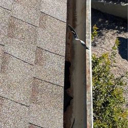 Aloha Specialty Roofing - Gutter were not reaffixed. Shingles, asphalt, and roof nails left in gutters.