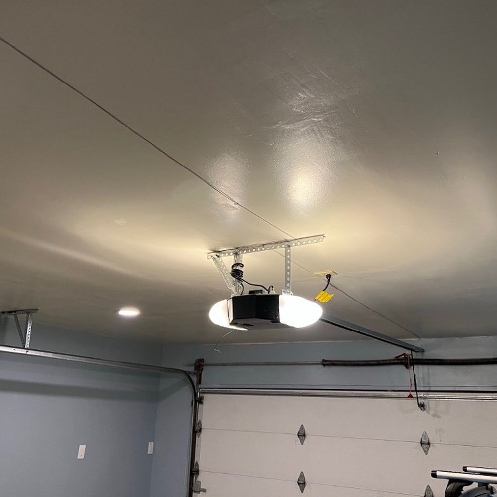 New Genie 3120HL garage door. The technician also reattached the garage door rails to the new ceiling as part of the installation.