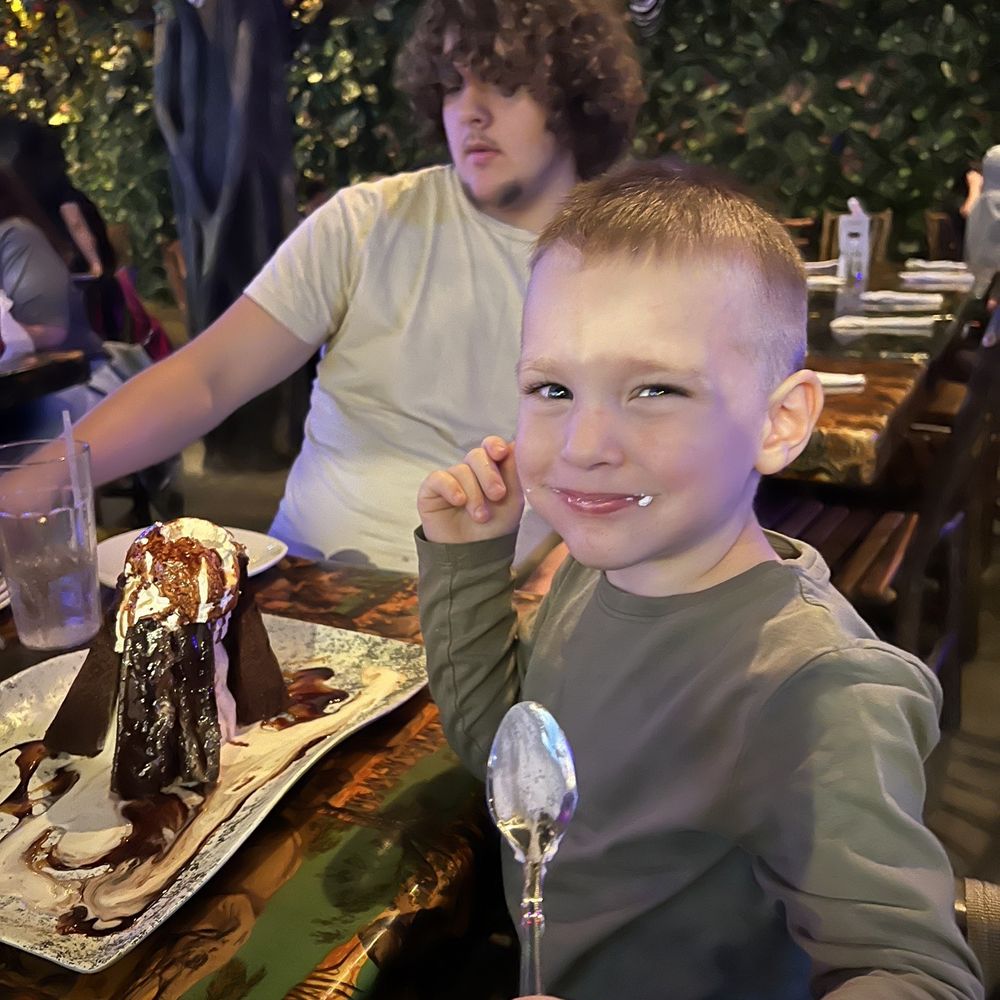 Rainforest Cafe - Little one enjoying his volcano cake! - American Near Me - Katy, Texas