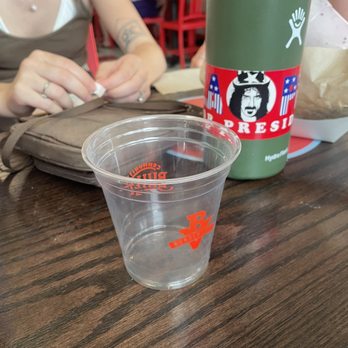 Burgerville - a woman sitting at a table with a plastic cup - Burgers Near Me - Albany, Oregon Burgerville - a woman sitting at a table with a plastic cup - Burgers Near Me - Albany, Oregon