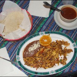 Puerto Viejo - My delicious MEX $25.00 breakfast of chorizo and eggs, refried beans, topped with shredded cheese and a stack of warm, corn tortillas.