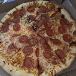 Supposed to be pepperoni half with black olives, but there's two slices with black olives Supposed to be pepperoni half with black olives, but there's two slices with black olives