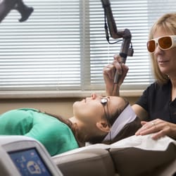 Clarkston Dermatology - Carol Ecker, R.N. performing Spectra laser treatment