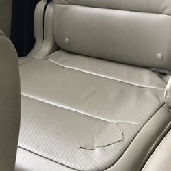 Avis Rent A Car - Inside of car was very dirty, ripped seat, stains on seats and carpeting, missing gas cap and scrapes on body.