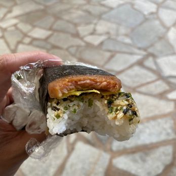 ABC Stores - a person holding a piece of food - Convenience Stores Near Me - Honolulu, Hawaii ABC Stores - a person holding a piece of food - Convenience Stores Near Me - Honolulu, Hawaii