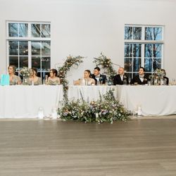 Dannette's Floral Boutique - Our repurposed arch, she placed the bottom of it around our head table.