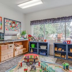 Our train table and shelves of accessible toys.