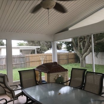 Palm Bay Aluminum - a patio with a table and chairs - General Contractors Near Me - Palm Bay, Florida Palm Bay Aluminum - a patio with a table and chairs - General Contractors Near Me - Palm Bay, Florida
