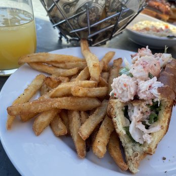 Milwaukee Sail Loft - Lobster roll with old bay fries and peach mosa cocktail - Seafood Near Me - Milwaukee, Wisconsin