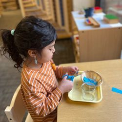 Pinyon Montessori - Learning how to use a scissors.