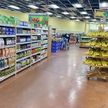 Trader Joe's - A grocery store aisle features a banana display on the right and shelves stocked with food and household items on the left. - Grocery Near Me - Batavia, Illinois