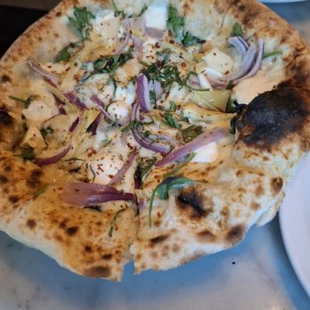 Vern's - This is the Spring Pie made with olive oil, mozzarella, taleggio, grilled artichoke, spinach, red onion, aleppo, mint. - New American Near Me - Rochester, New York Vern's - This is the Spring Pie made with olive oil, mozzarella, taleggio, grilled artichoke, spinach, red onion, aleppo, mint. - New American Near Me - Rochester, New York