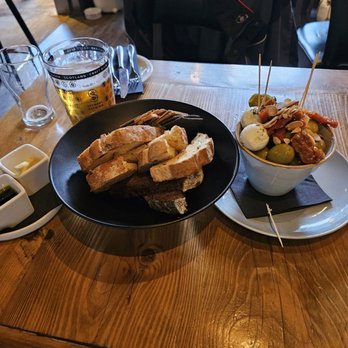 The Magnum Restaurant and Bar - "Bread Selection" with butter & olive oil/balsamic vinegar; Small Plate of green olives, sun-dried tomatoes, and spreadable goat cheese. - Pubs Near Me - Edinburgh, EDH