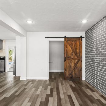 Step Up Home Improvements - a brick wall with a barn door - Flooring Near Me - Tampa, Florida Step Up Home Improvements - a brick wall with a barn door - Flooring Near Me - Tampa, Florida