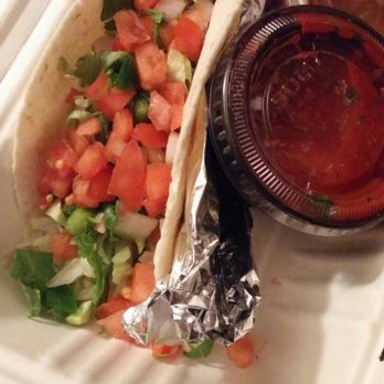 Quesada Burritos & Tacos - Fish, soft flour tortilla topped with cilantro, red onions, and tomatoes with a side of their spicy salsa (clear container salsa) - Mexican Near Me - Windsor, Ontario
