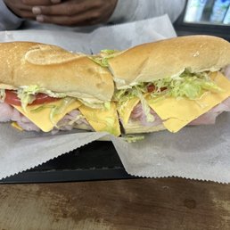 Ham and American cheese on a hero, with lettuce, tomato. Ham and American cheese on a hero, with lettuce, tomato.