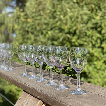 Goose Watch Winery - a row of wine glasses on a wooden railing - Wineries Near Me - Romulus, New York Goose Watch Winery - a row of wine glasses on a wooden railing - Wineries Near Me - Romulus, New York