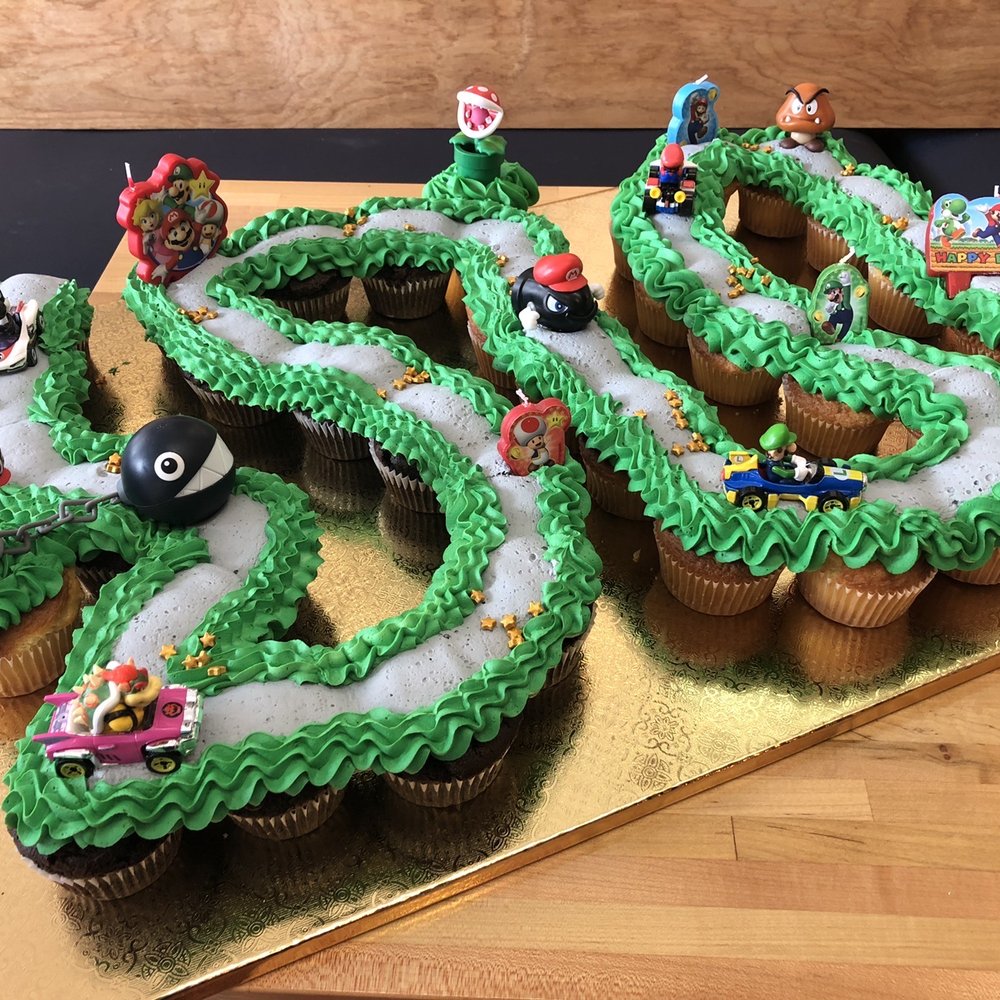 Miss Mamie's - Mario Kart cupcake cake, 36 cupcakes. Some cupcakes were vanilla and some were chocolate. Frosting was vanilla. - Bakeries Near Me - Marietta, Georgia Miss Mamie's - Mario Kart cupcake cake, 36 cupcakes. Some cupcakes were vanilla and some were chocolate. Frosting was vanilla. - Bakeries Near Me - Marietta, Georgia
