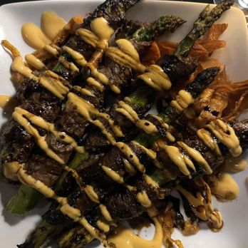 Vernon's Speakeasy - Beef steak wrapped asparagus with Sriracha sauce and fried carrots. - Steakhouses Near Me - Los Ranchos, New Mexico