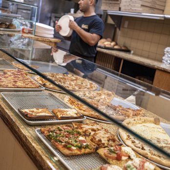 SaVino's Restaurant & Pizzeria - a man serving pizzas - Pizza Near Me - Lynbrook, New York SaVino's Restaurant & Pizzeria - a man serving pizzas - Pizza Near Me - Lynbrook, New York