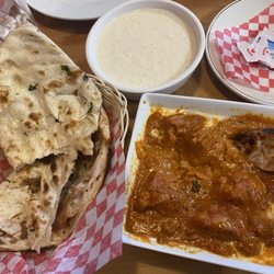 Spirit of India - Left to right: garlic naan, rice pudding, extra spicy buttered chicken.