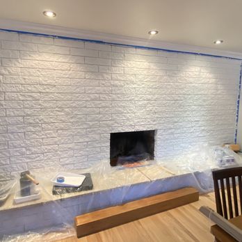 Art’s Remodeling - Hanging a floating shelves above the fireplace - Handyman Near Me