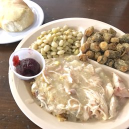Chicken and dressing with okra and butter peas. Biscuit on side
