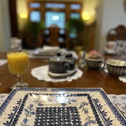 Capitol Hill Mansion Bed & Breakfast Inn - A place setting at the main dining room facing the living room with fire place.