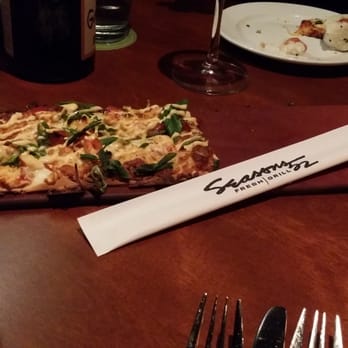Seasons 52 - Grilled Garlic Pesto Chicken Flatbread. Doesn't look like much... until you sink your teeth into it. - New American Near Me - Cincinnati, Ohio Seasons 52 - Grilled Garlic Pesto Chicken Flatbread. Doesn't look like much... until you sink your teeth into it. - New American Near Me - Cincinnati, Ohio