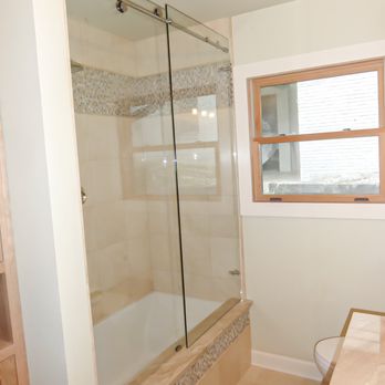 MHM Remodeling - Bathtub With frameless glass sliding enclosure - General Contractors Near Me MHM Remodeling - Bathtub With frameless glass sliding enclosure - General Contractors Near Me