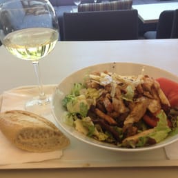 Salad with chicken and a medium glass of wine Salad with chicken and a medium glass of wine