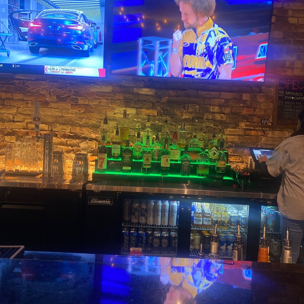 7 Iron Social - a man playing a video game - Sports Bars Near Me - Madison, Wisconsin