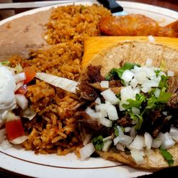 Combo platter; carnitas taco, chorizo enchilada and chicken Verde tamale with beans and rice on the side.