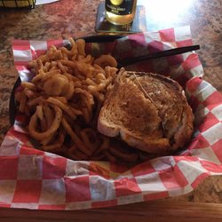 Buca's Bar & Grill - Delicious patty melt with mountain of onion strings.