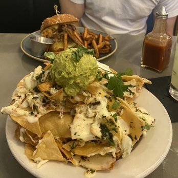 Some Random Bar - Crab nachos and brisket sandwich in the background - New American Near Me - Seattle, Washington