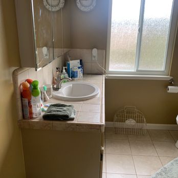 Ontimio Builders - a bathroom with a sink and a window - General Contractors Near Me Ontimio Builders - a bathroom with a sink and a window - General Contractors Near Me