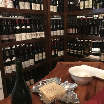 Bin 604 Wine + Spirits - a person holding a glass of wine - Beer, Wine & Spirits Near Me - Baltimore, Maryland