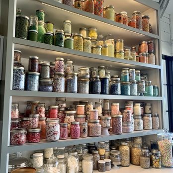 Sugar and Scribe  - The wall of glitter and cake decor. - Bakeries Near Me - La Jolla, California