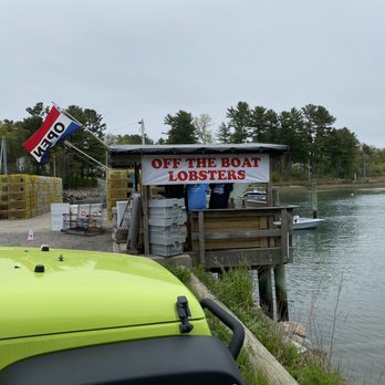 Off the Boat Lobster - a green jeep parked next to a dock - Seafood Markets Near Me - York, Maine