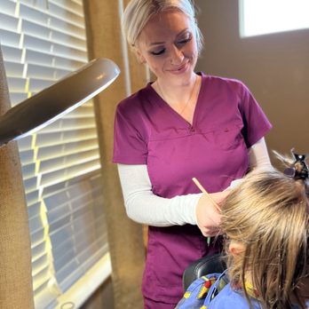 DELYCE - Taking a close look under focused lighting helps to best see even the tiniest eggs. - Lice Services Near Me