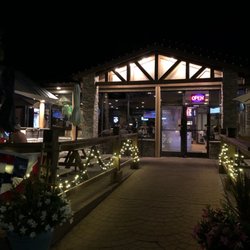 Pelican's Perch Bar & Grill - Outdoor seating/front/entrance at night.
