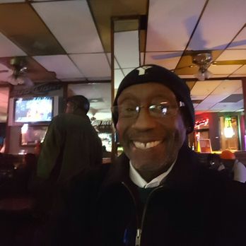 Harlem Tap Room - a man with glasses smiling - Bars Near Me - Saint Louis, Missouri Harlem Tap Room - a man with glasses smiling - Bars Near Me - Saint Louis, Missouri