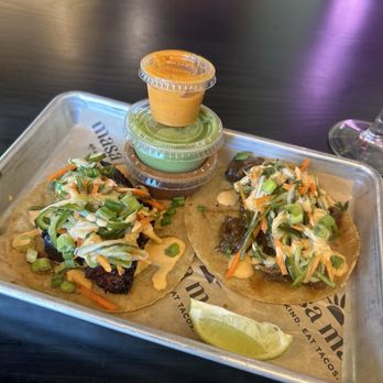 Masa Masa - Pork belly taco on the left, Korean beef on the right. Salsas are mild, medium, and hot (bottom to top) - Tacos Near Me - Roseville, California Masa Masa - Pork belly taco on the left, Korean beef on the right. Salsas are mild, medium, and hot (bottom to top) - Tacos Near Me - Roseville, California