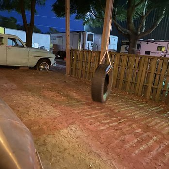 Spokes & Bones Saloon - a tire hanging on a fence - Sports Bars Near Me - Murrells Inlet, South Carolina