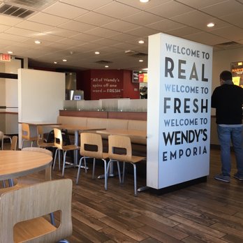 Wendy's - a woman sitting at a table in a restaurant - Burgers Near Me - Emporia, Virginia
