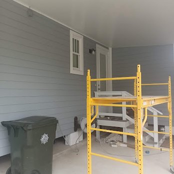 Godwin Construction - a yellow scaffolding on a porch - Painters Near Me Godwin Construction - a yellow scaffolding on a porch - Painters Near Me
