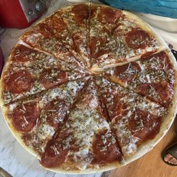 a pepperoni pizza on a table